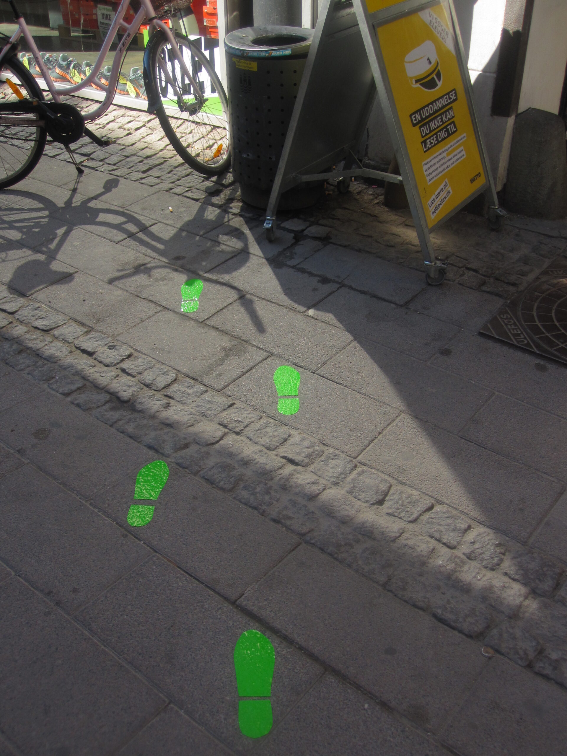 Clean-City-Footprints-to-garbagecan-behind-sign